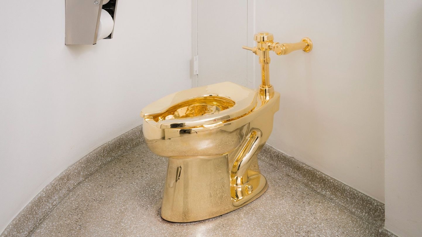 In this undated photo provided by the Solomon R. Guggenheim Museum, an18-karat gold toilet is shown in the museum's 14th floor restroom at the Solomon R. Guggenheim Museum in New York. As part of the museum's "America" exhibit, Italian artist Maurizio Cattelan replaced the standard toilet with the fully functional replica cast in gold. (Kristopher McKay/Solomon R. Guggenheim Museum via AP)
