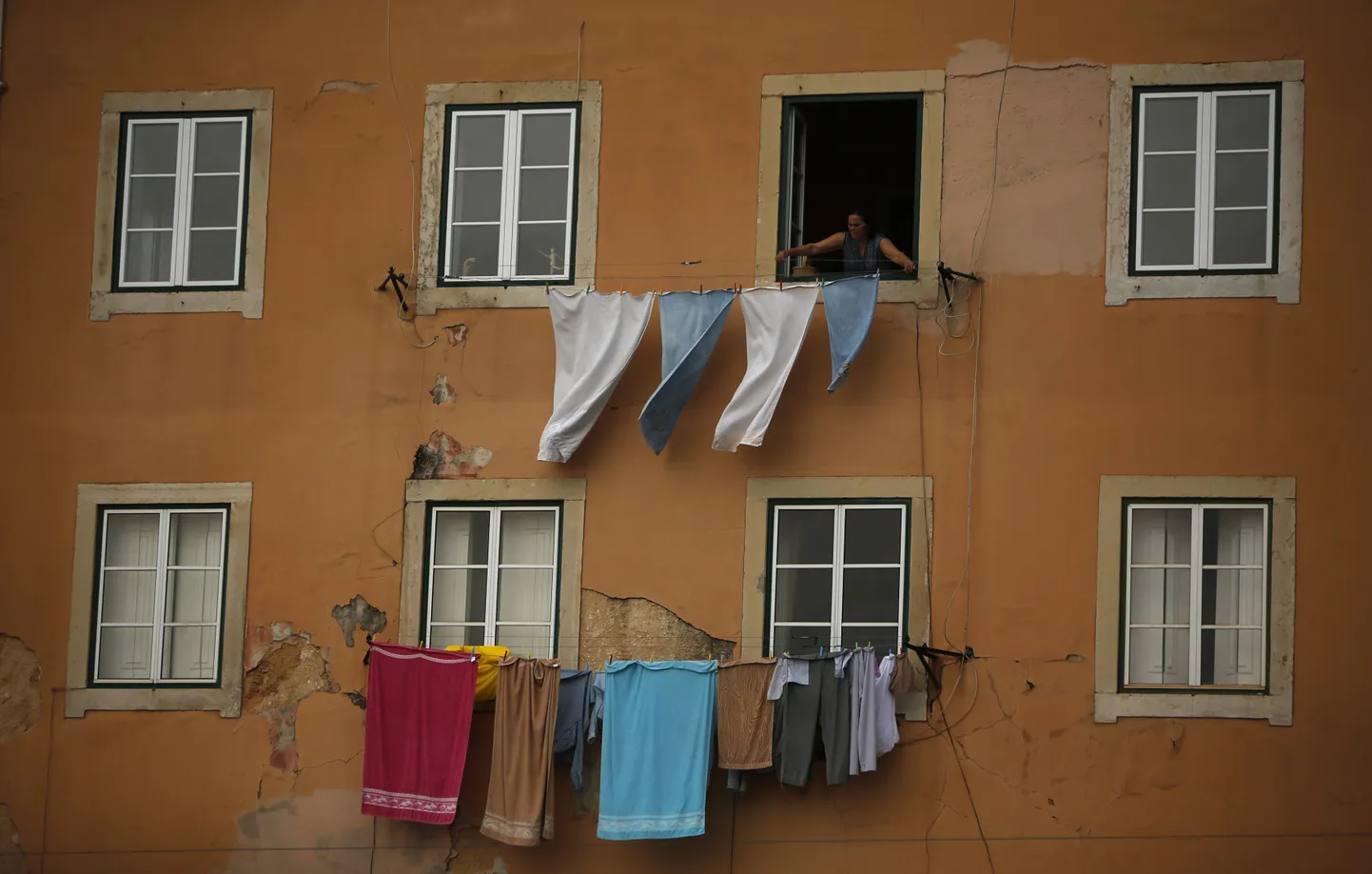 Naine riputab Lissabonis pesu kuivama