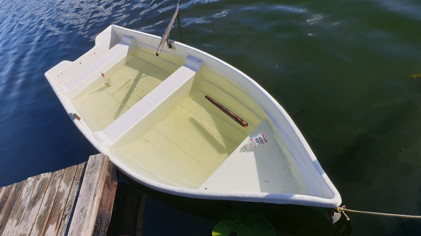 Полная воды и со сломанными веслами лодка в озере Лыйдла.