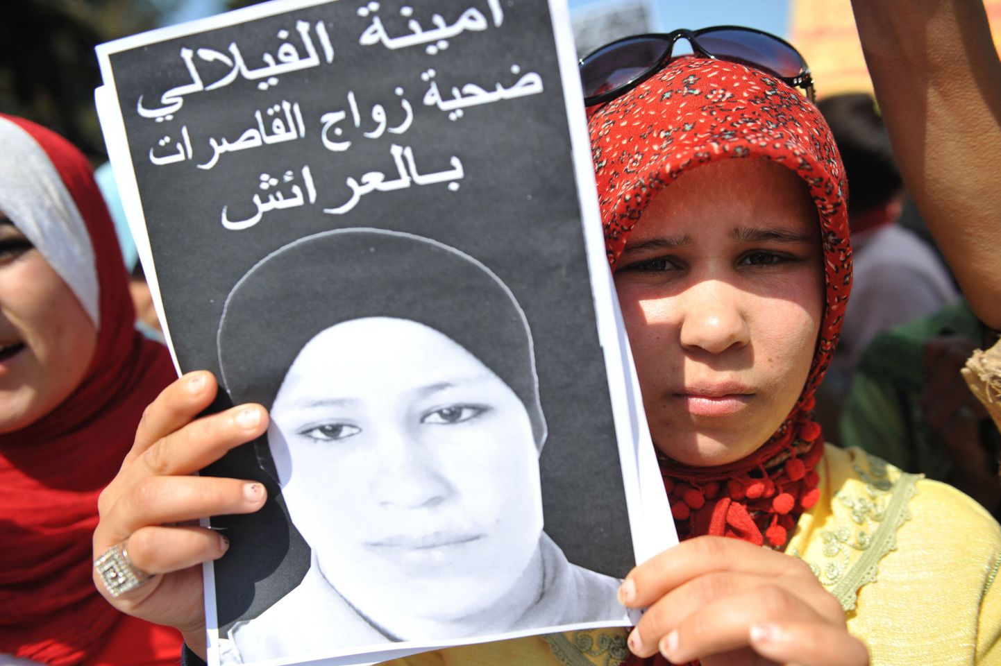 Sundabielu tõttu enesetapu sooritanud Amina Al Filali õde Hamida osales 2012. aastal julma vägistamisseaduse vastastel protestidel õe näopildiga plakatiga.