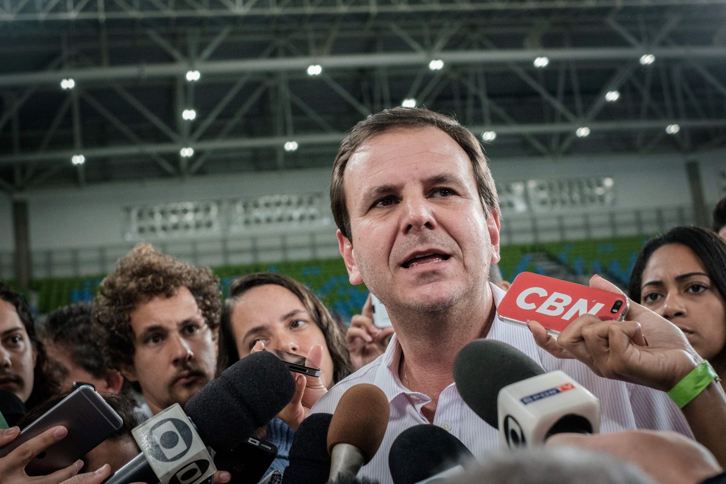 Rio de Janeiro's Mayor Eduardo Paes speaks to the press during the inauguration of the Carioca Arena 2 at the Olympic Park in Rio de Janeiro, Brazil, on May 14, 2016.
The Carioca Arena 2 will host Judo and Wrestling competitions during the Rio 2016 Olympic games and Bocha during the Paralympic games. / AFP PHOTO / YASUYOSHI CHIBA