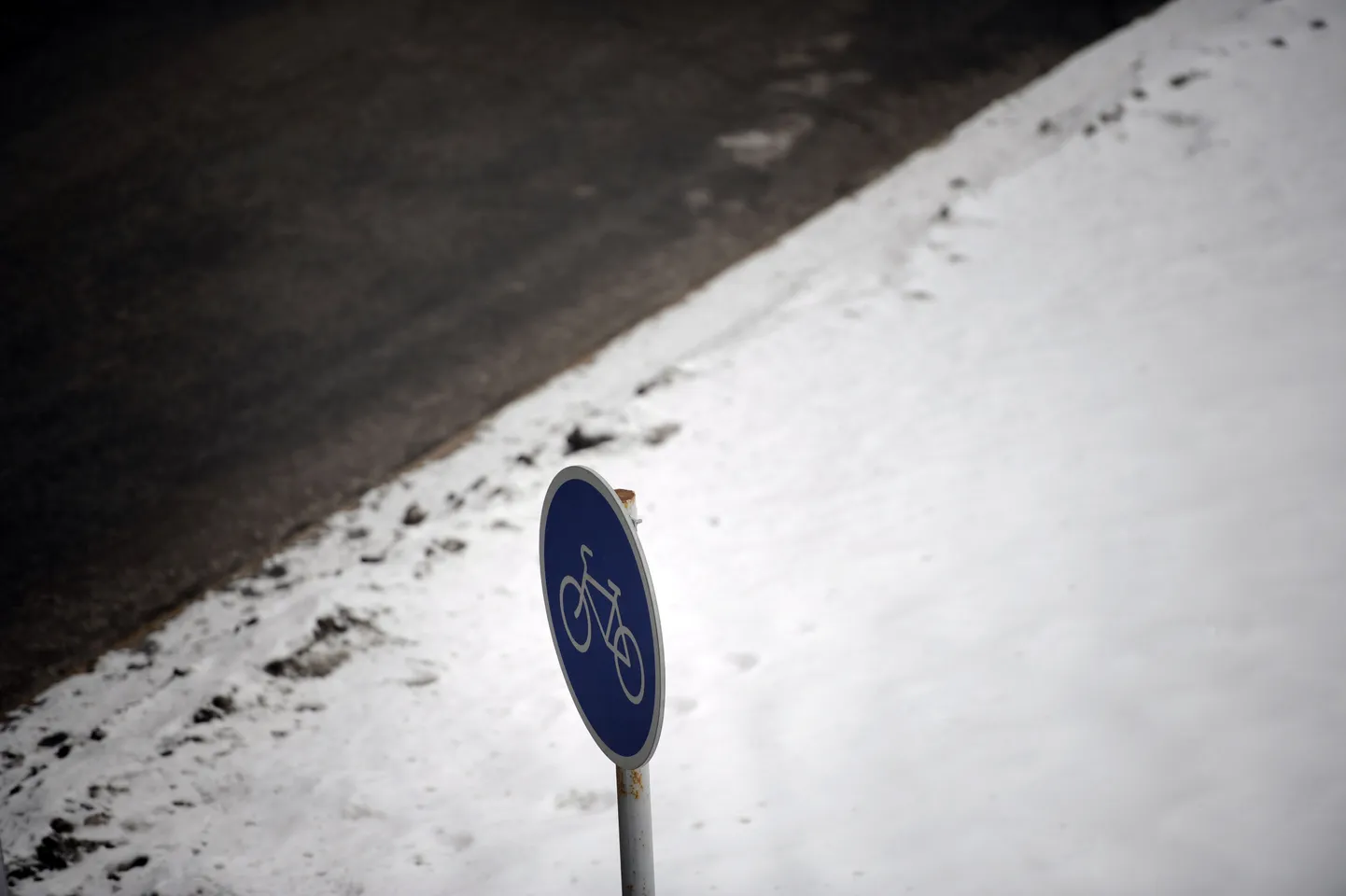 Liiklusmärk lumisel teepervel.