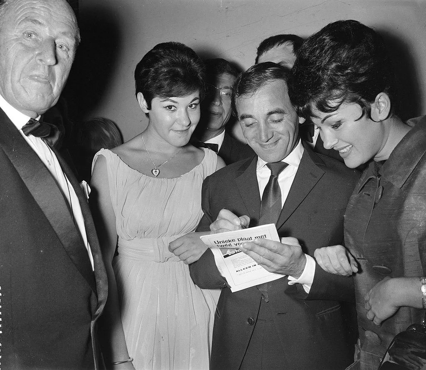 Charles Aznavour vaimustatud daamidele autogramme jagamas.