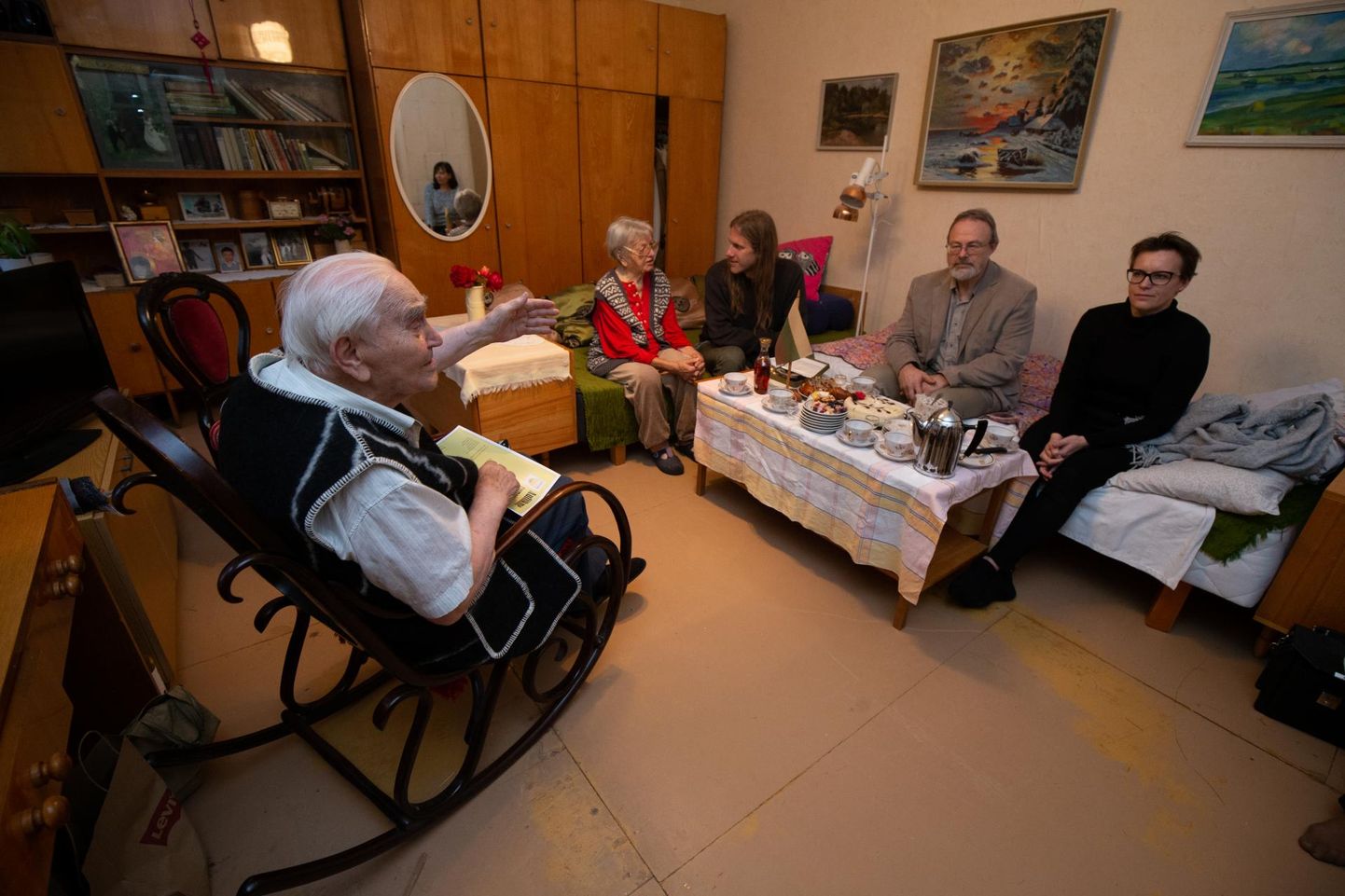Kiiktoolis istuva Leo Kunmani pika elu mälestusi kuulavad supilinlased (paremalt) Kristiina Praakli, Heiki Valk, Mart Hiob ja ta oma naine Irena Kunman.