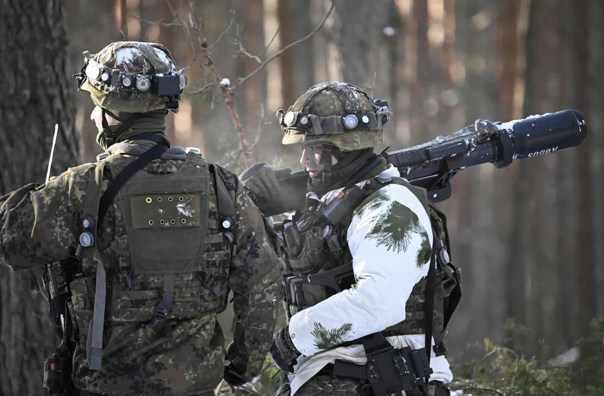 A soldier of the German armed forces Bundeswehr carries an AGDUS laser-based system to simulate actual battle for training purposes during an exercise of the German contingent of NATO's Enhanced Forward Presence on March 7, 2023 in Pabrade, Lithuania.