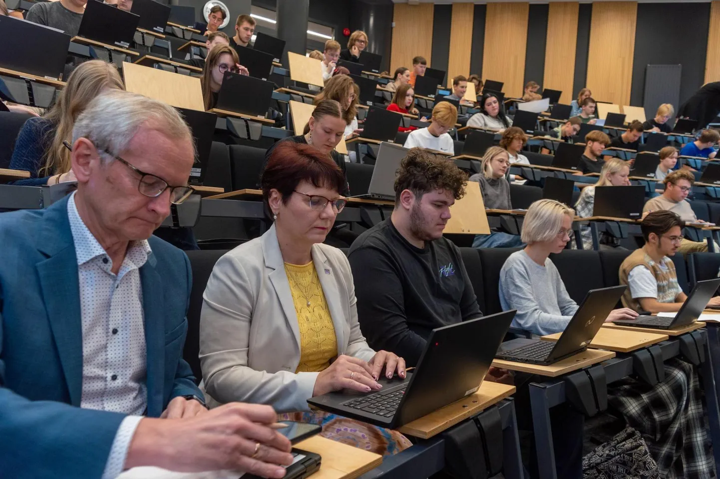 Kohtla-Järve gümnaasiumi 10. ja 11. klassi õpilased koos Tallinna
Tehnikaülikooli rektori Tiit Landi ja Virumaa Kolledži direktori Mare Roosilehega matemaatikaülesandeid lahendamas.