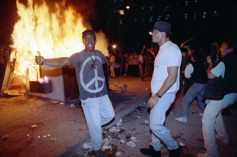  April 29, 1992 demonstrators protest the verdict in the Rodney King beating case in front of the Los Angeles Police Department headquarters in Los Angeles. 