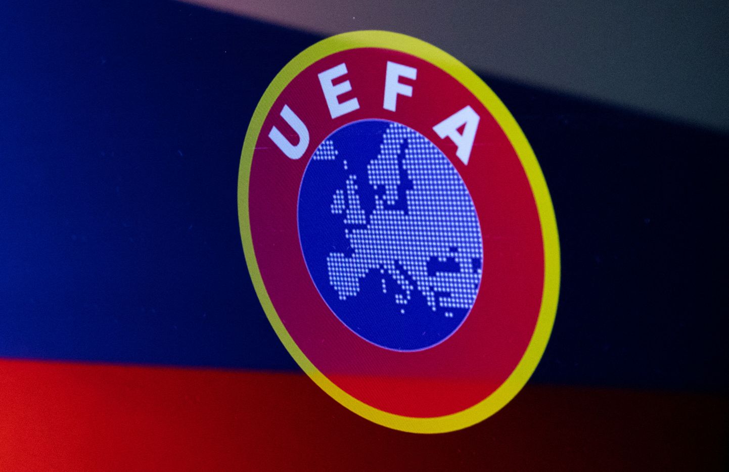 Лого УЕФА на фоне российского флага.