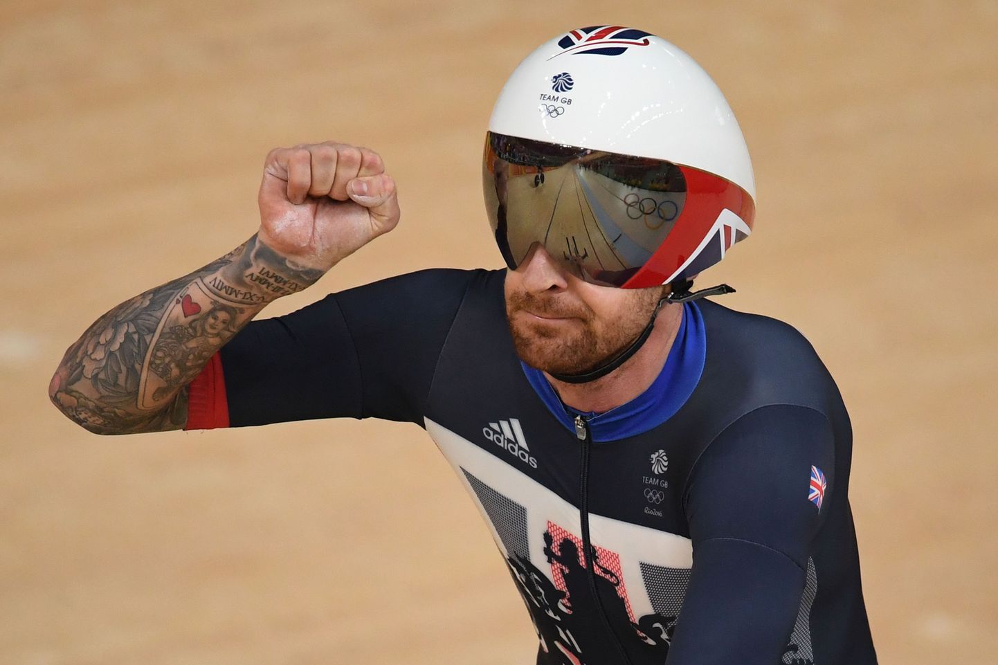 Britain's Bradley Wiggins celebrates after setting a world record after competing with teammates in the men's Team Pursuit qualifying track cycling event at the Velodrome during the Rio 2016 Olympic Games in Rio de Janeiro on August 12, 2016. / AFP PHOTO / Eric FEFERBERG