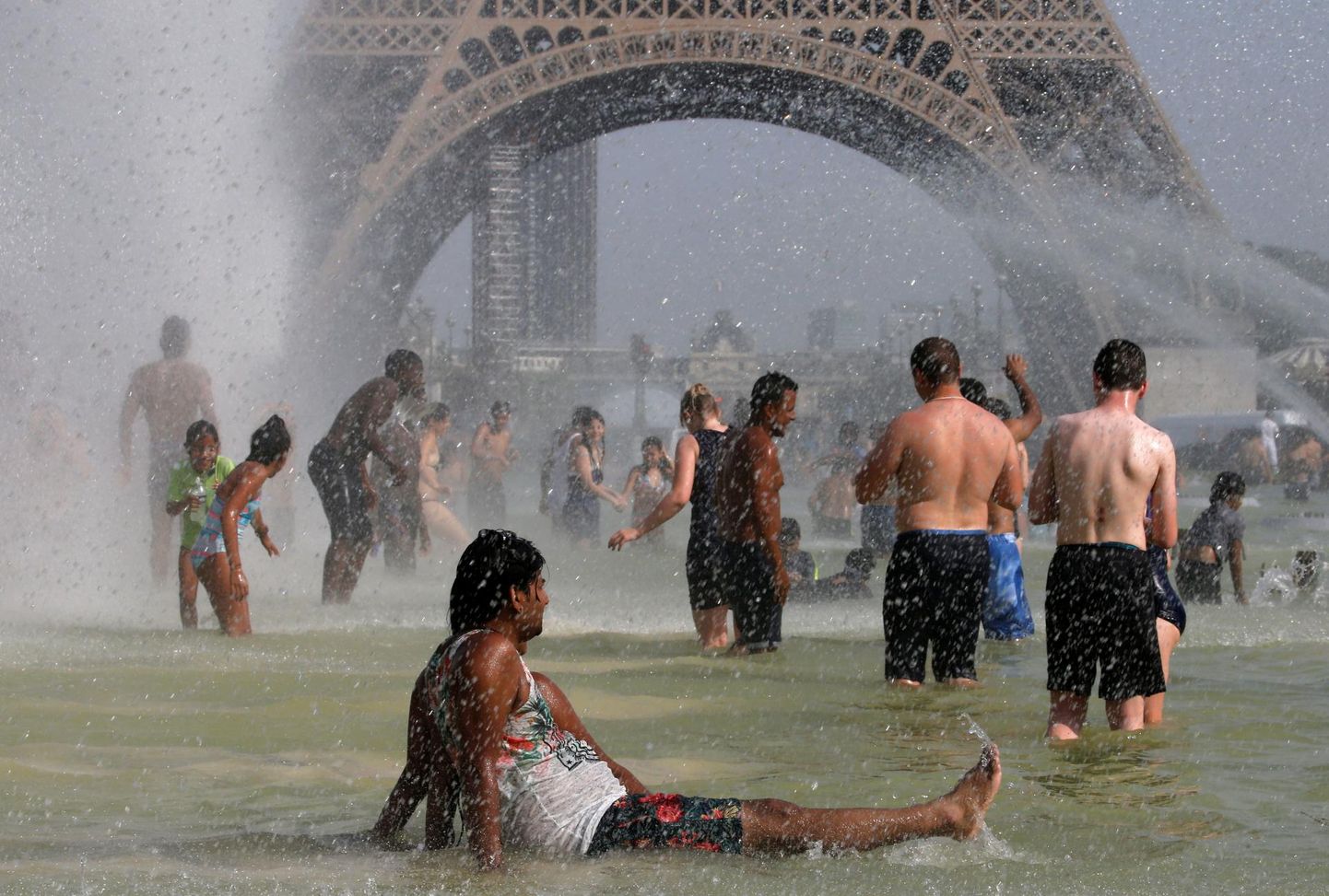 Inimesed jahutavad end Pariisis Eiffeli torni juures Trocadero purskkaevudes. Prantsusmaa pealinnas sündis eile kõigi aegade kuumarekord. 